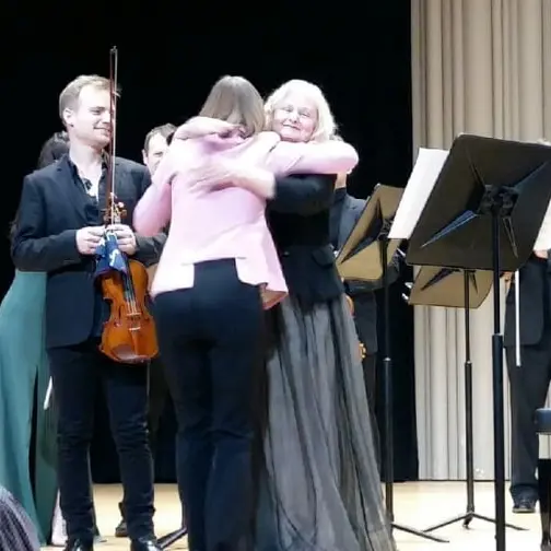 Christina with composer Larysa Kuzmenko hugging her and violinist Marc Djokic after the world premiere of a concerto she wrote for Christina and Marc